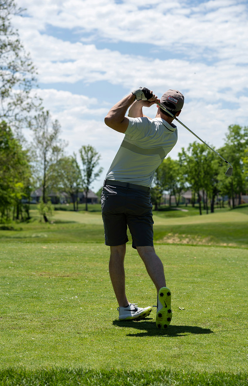 man-in-white-t-shirt-and-black-shorts-holding-golf-club